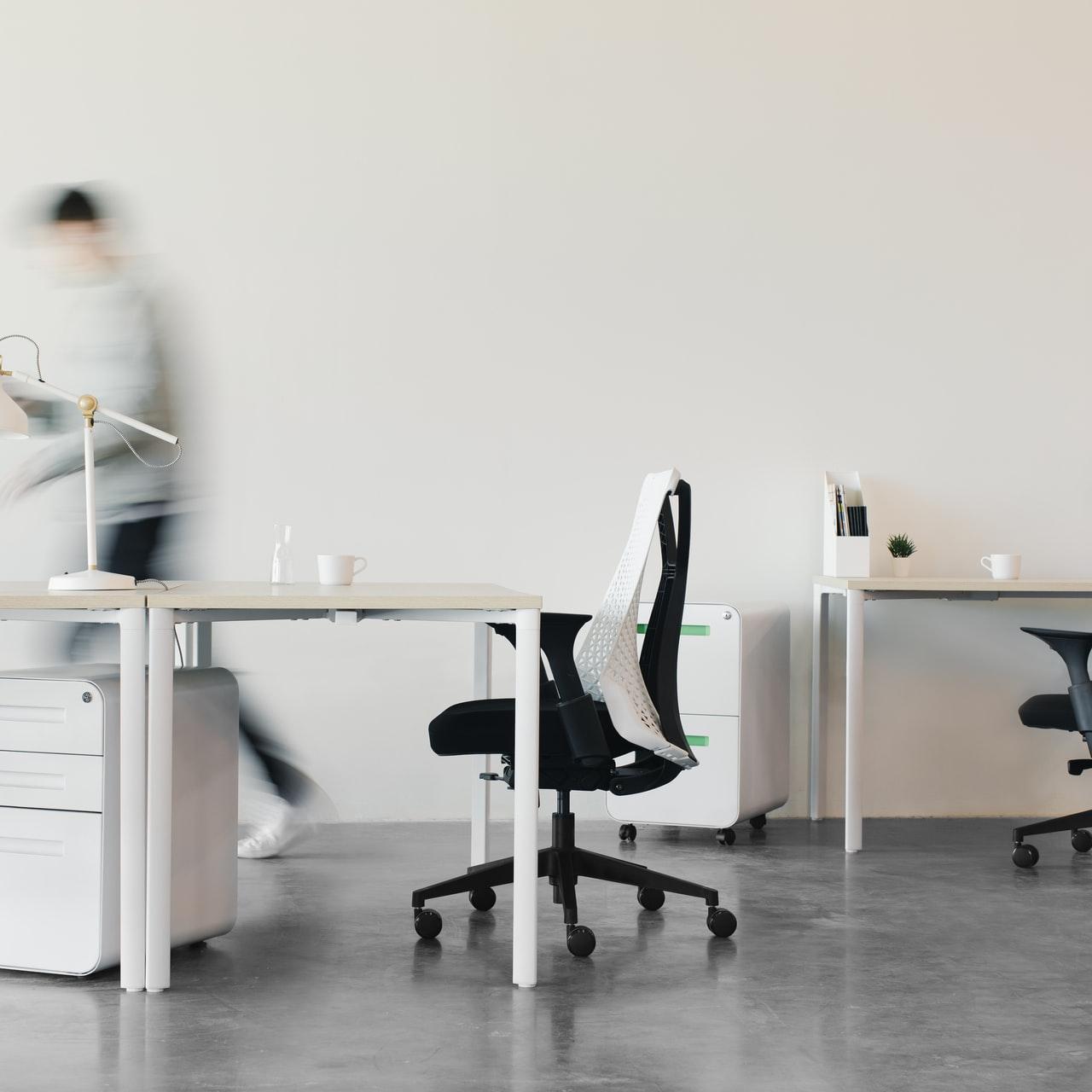 woman in white long sleeve shirt sitting on black office rolling chair